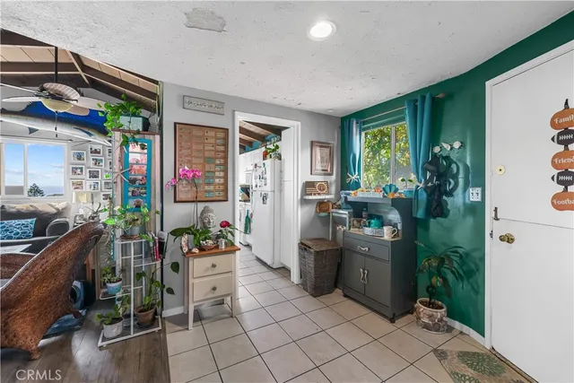 a kitchen with furniture a counter top space and stainless steel appliances