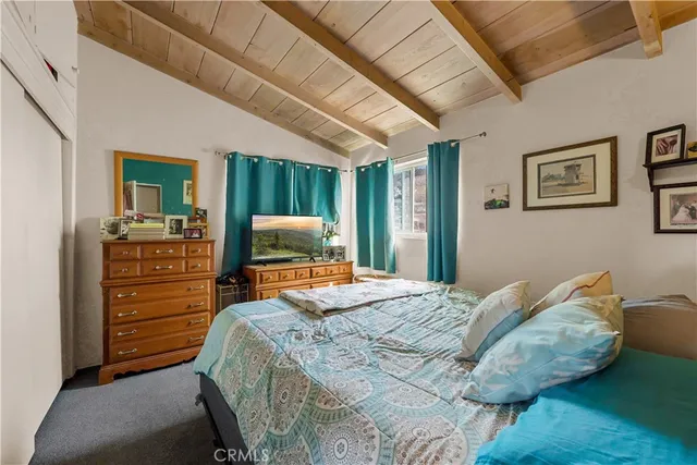 a bedroom with a bed and a desk