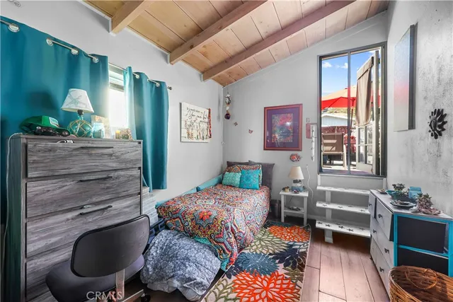 a room with furniture a window and a flat screen tv