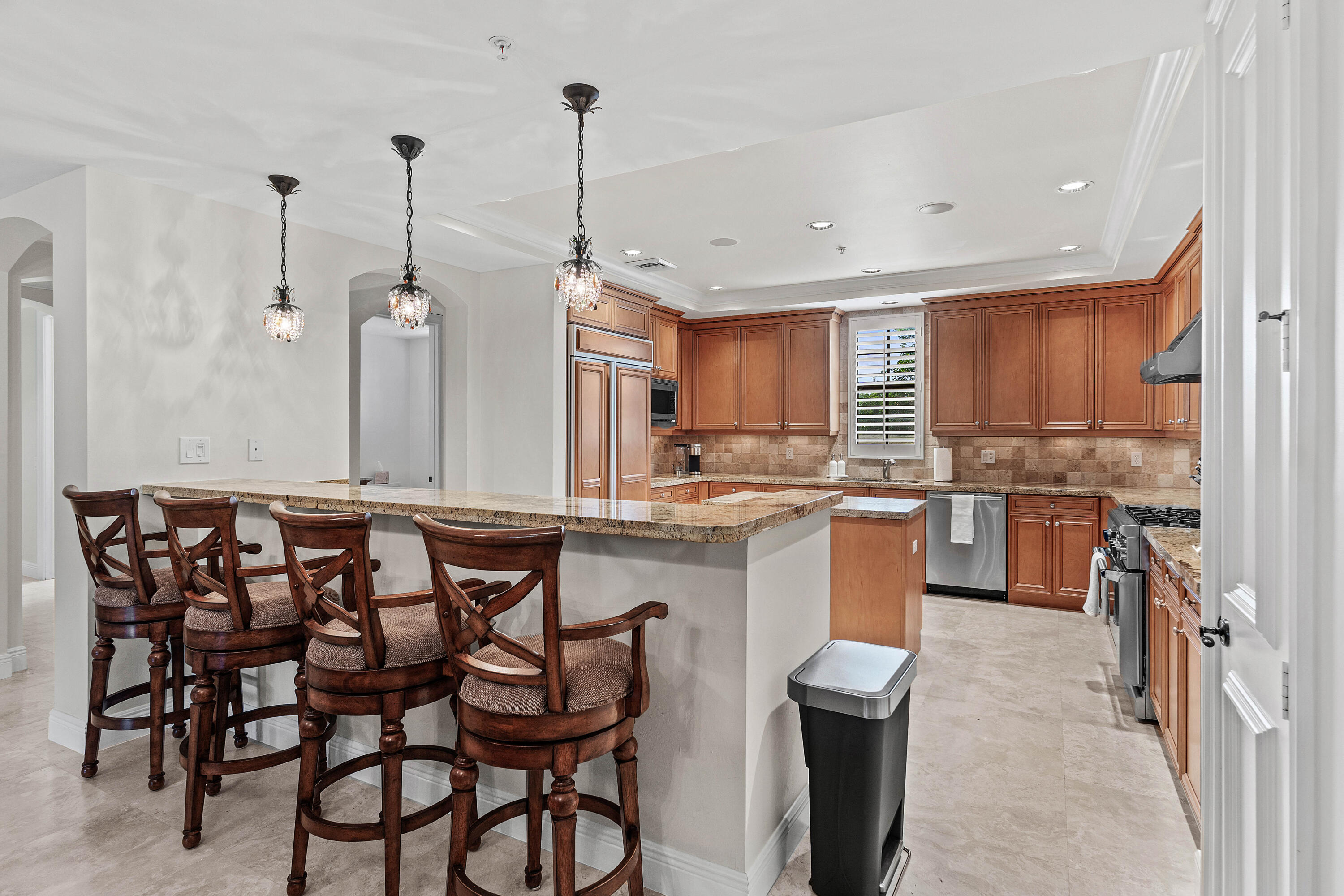 110 Gleason Street, Unit 203 Delray Beach, FL 33483 - Photo 5 of 25 a kitchen with a table chairs microwave and cabinets