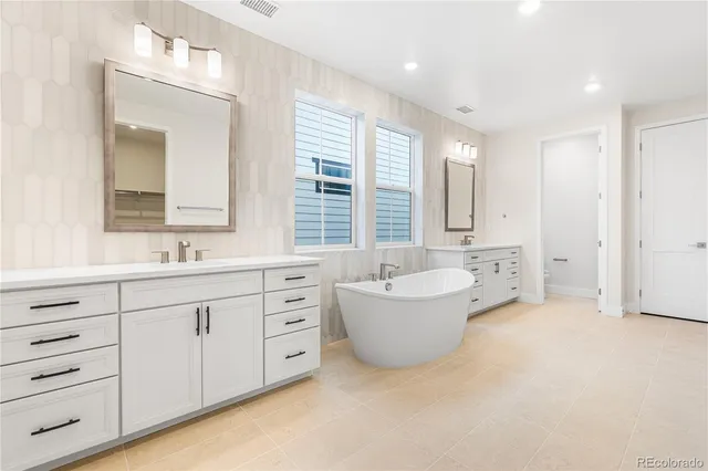 a bedroom with a bed a couch and a window