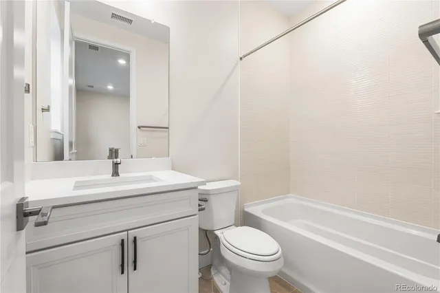 a bathroom with a sink a toilet and a bathtub