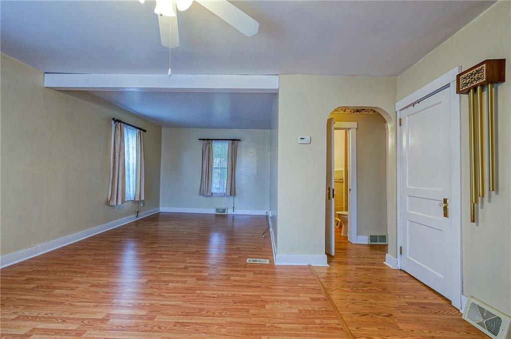 1224 Eckert Road Monaca, PA 15061 - Photo 2 of 18 a view of an empty room with wooden floor and a window
