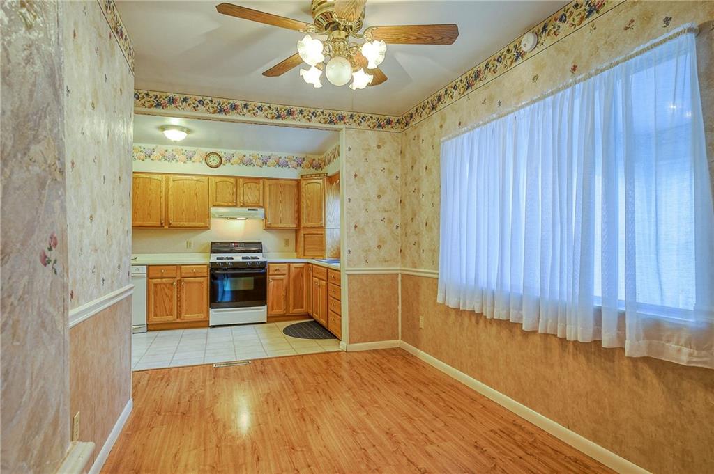 1224 Eckert Road Monaca, PA 15061 - Photo 4 of 18 a large kitchen with a wooden floor and stainless steel appliances