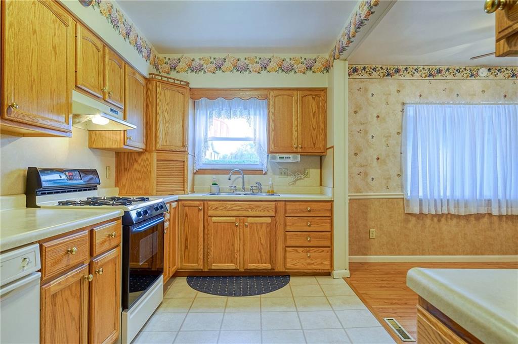 1224 Eckert Road Monaca, PA 15061 - Photo 6 of 18 a kitchen with stainless steel appliances a stove a sink and a refrigerator