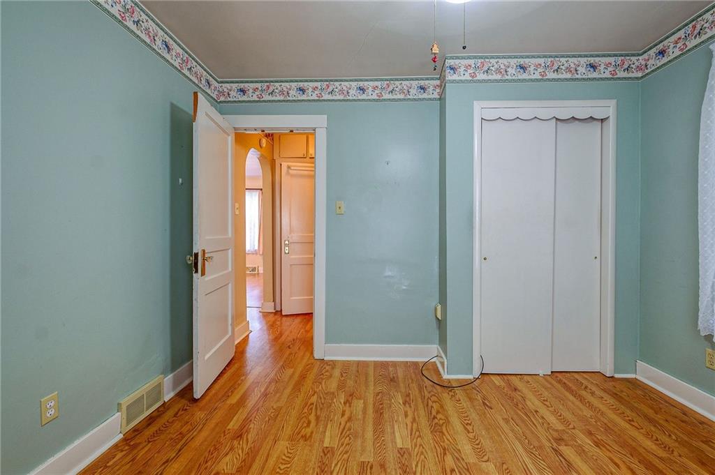 1224 Eckert Road Monaca, PA 15061 - Photo 7 of 18 a view of empty room with wooden floor and fan