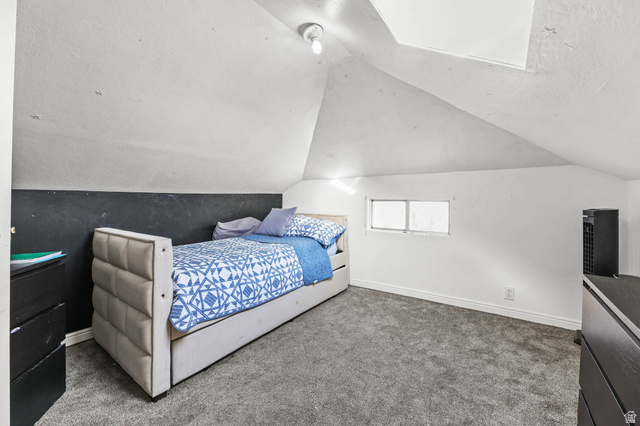 7609 Mountain View Road Lake Point, UT 84074 - Photo 11 of 16 Carpeted bedroom with baseboards and vaulted ceiling