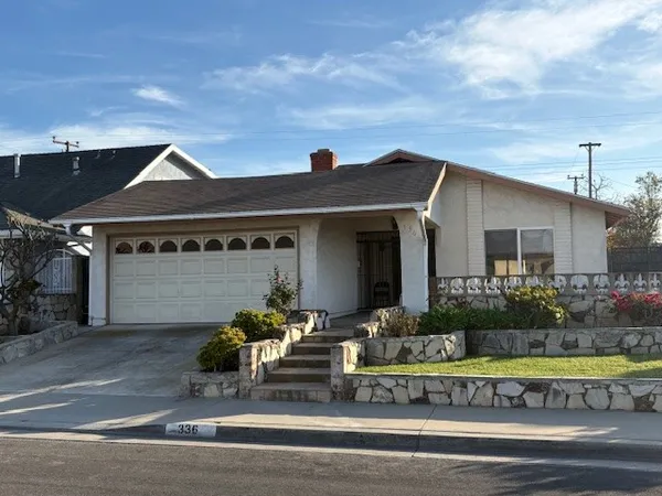 a front view of house with garage and outdoor seating