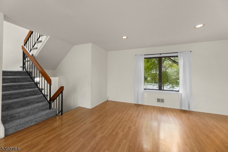 65 Diamond Lane Old Bridge, NJ 08857 - Photo 11 of 33 a view of an empty room with wooden floor and a window