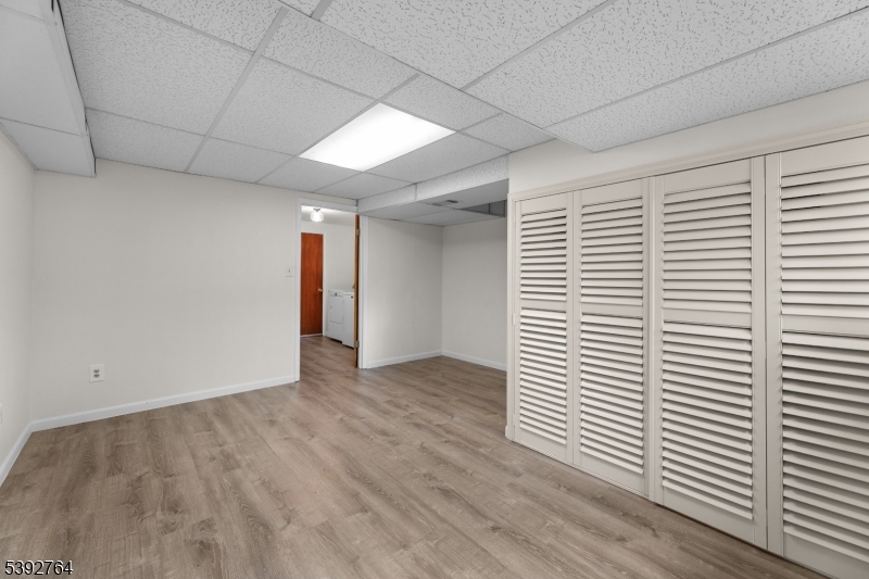 65 Diamond Lane Old Bridge, NJ 08857 - Photo 22 of 33 a view of an empty room with wooden floor and a window