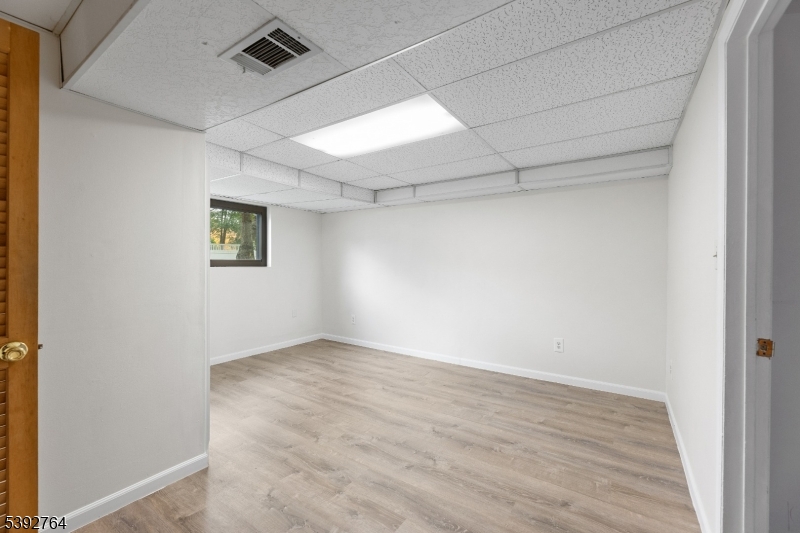 65 Diamond Lane Old Bridge, NJ 08857 - Photo 23 of 33 an empty room with wooden floor and windows
