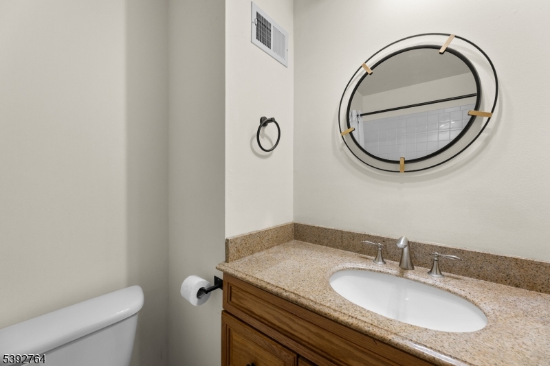 65 Diamond Lane Old Bridge, NJ 08857 - Photo 27 of 33 a bathroom with a granite countertop toilet a sink and a mirror
