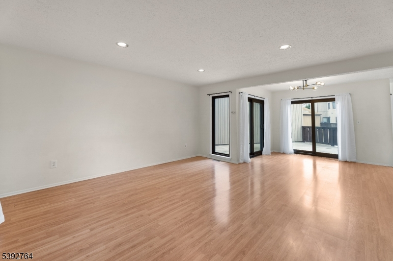 65 Diamond Lane Old Bridge, NJ 08857 - Photo 5 of 33 a view of an empty room with wooden floor and windows