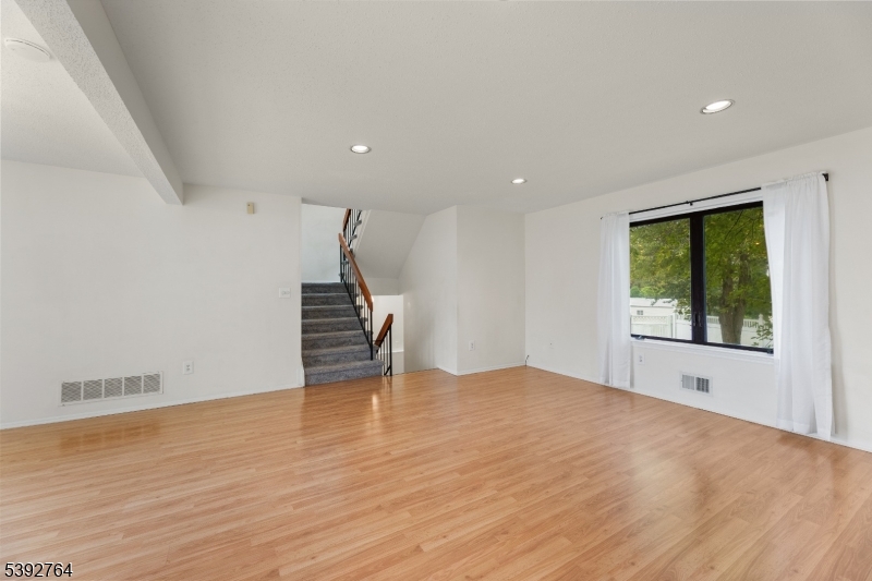 65 Diamond Lane Old Bridge, NJ 08857 - Photo 6 of 33 a view of an empty room with wooden floor and a window