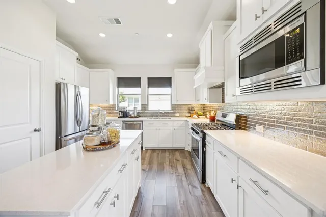 a kitchen with a sink stove and refrigerator