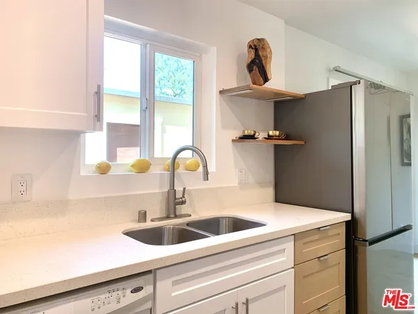 a white refrigerator freezer sitting in a kitchen