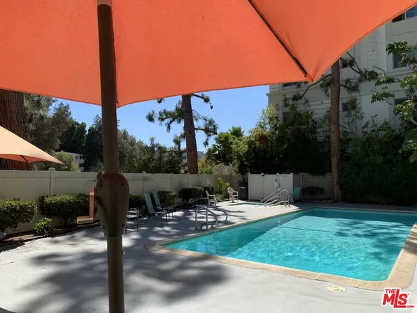 a view of a table and chairs under an umbrella