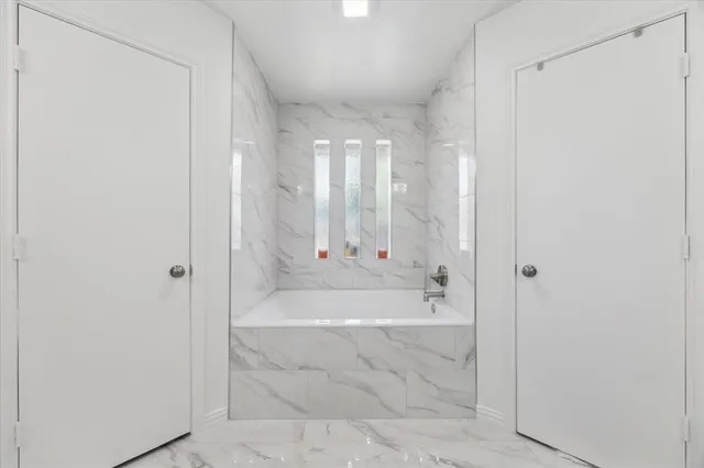 a bathroom with a bathtub and a shower