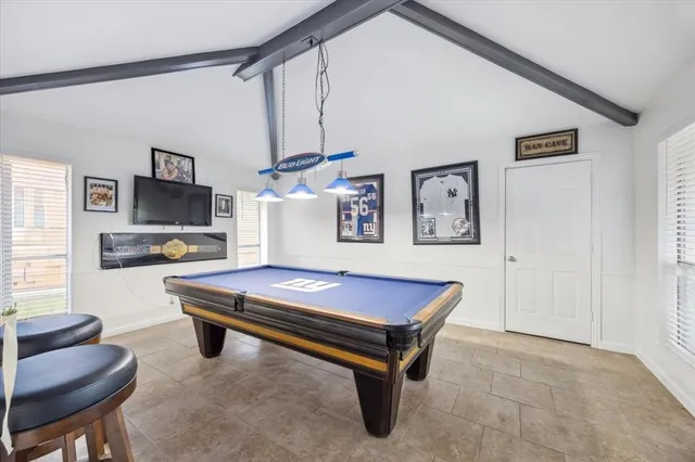 a room with furniture pool table and flat screen tv