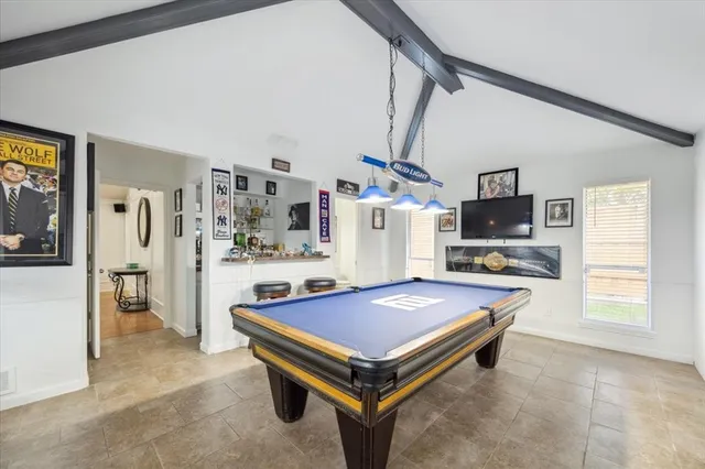 a room with pool table and flat screen tv