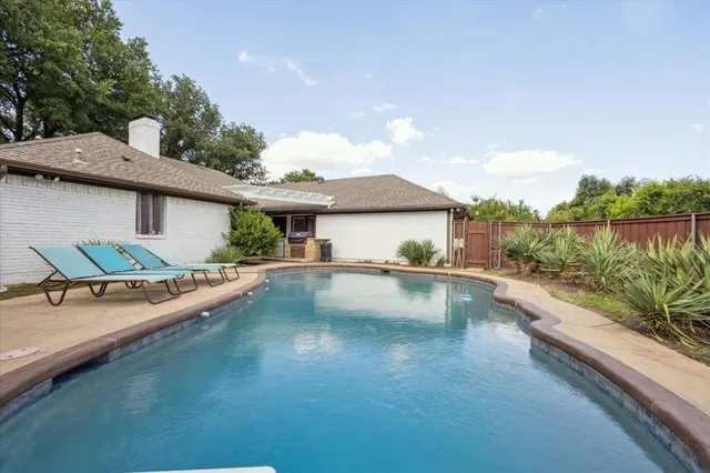 a view of a house with swimming pool and sitting area