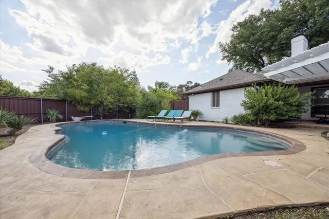 a view of a swimming pool with a yard