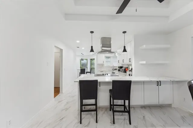 a kitchen with a sink cabinets and wooden floor