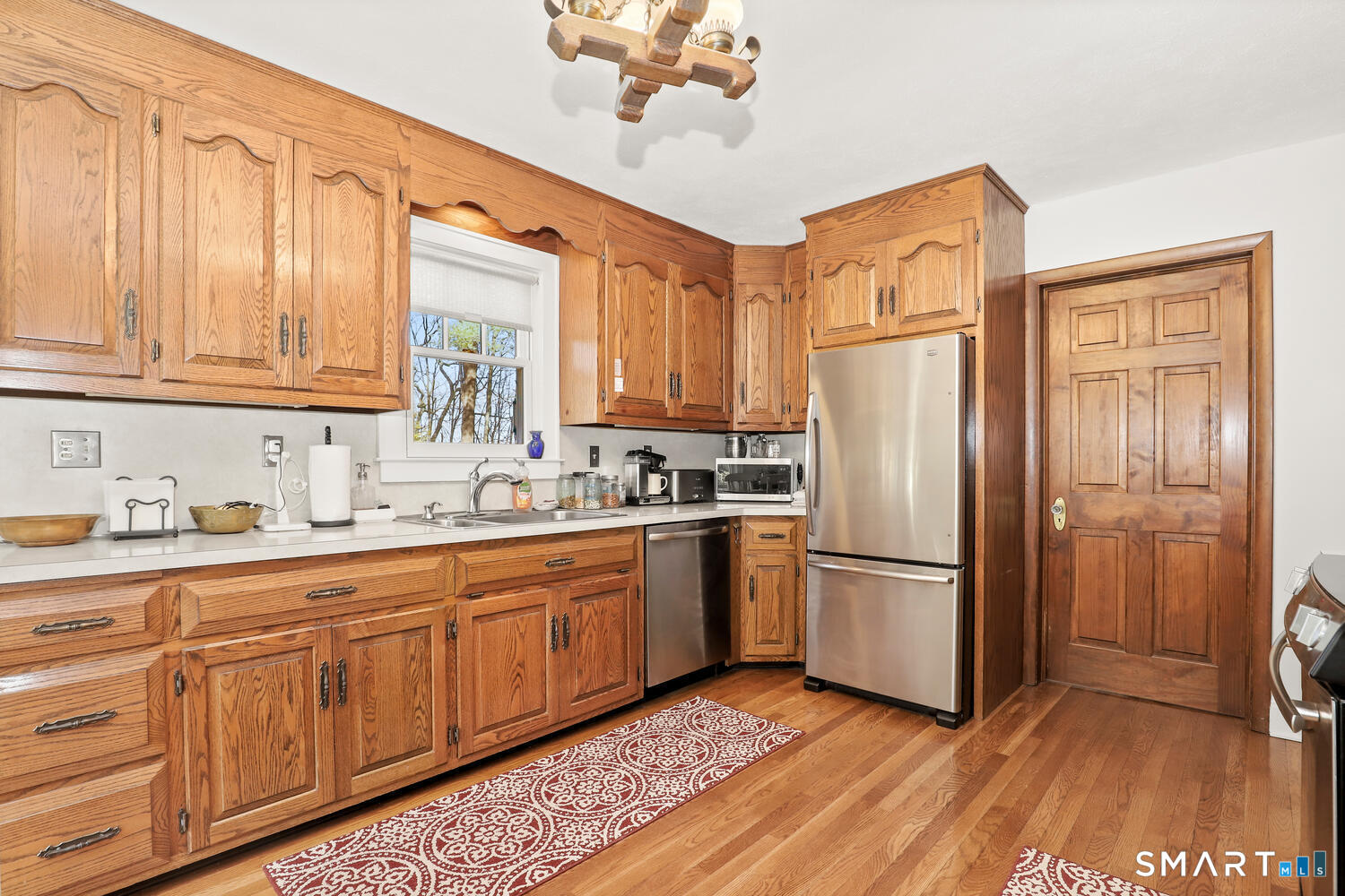 4 Kay Lane Newtown, CT 06470 - Photo 12 of 38 a kitchen with granite countertop stainless steel appliances a refrigerator and a sink