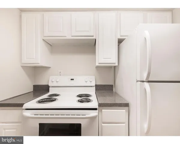 a kitchen with a white cabinets and white appliances