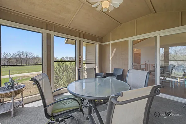 a view of a dining room with furniture window and outside view