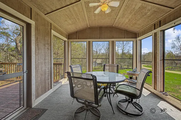 a view of a dining room with furniture large windows and wooden floor