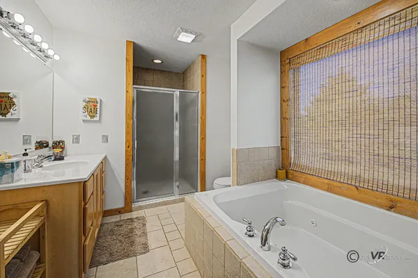 a bathroom with a tub sink and mirror