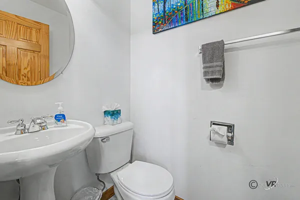 a white toilet sitting next to a bathroom sink