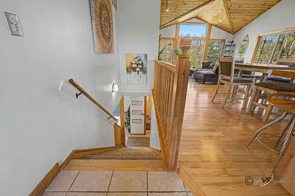 a view of entryway and hall with wooden floor