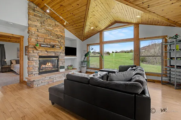 a living room with furniture large window and a fireplace