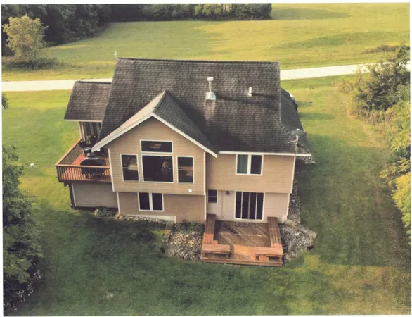 a front view of house with yard and ocean view