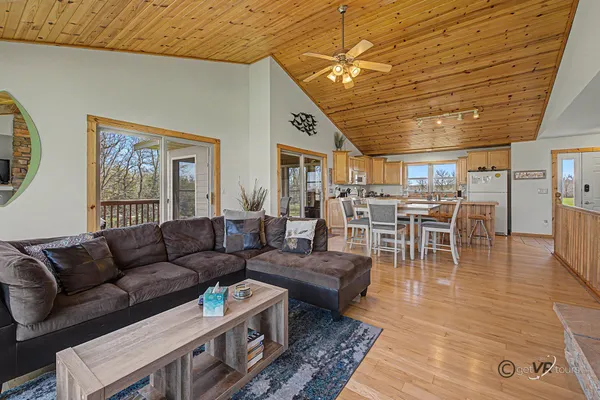 a living room with furniture and wooden floors