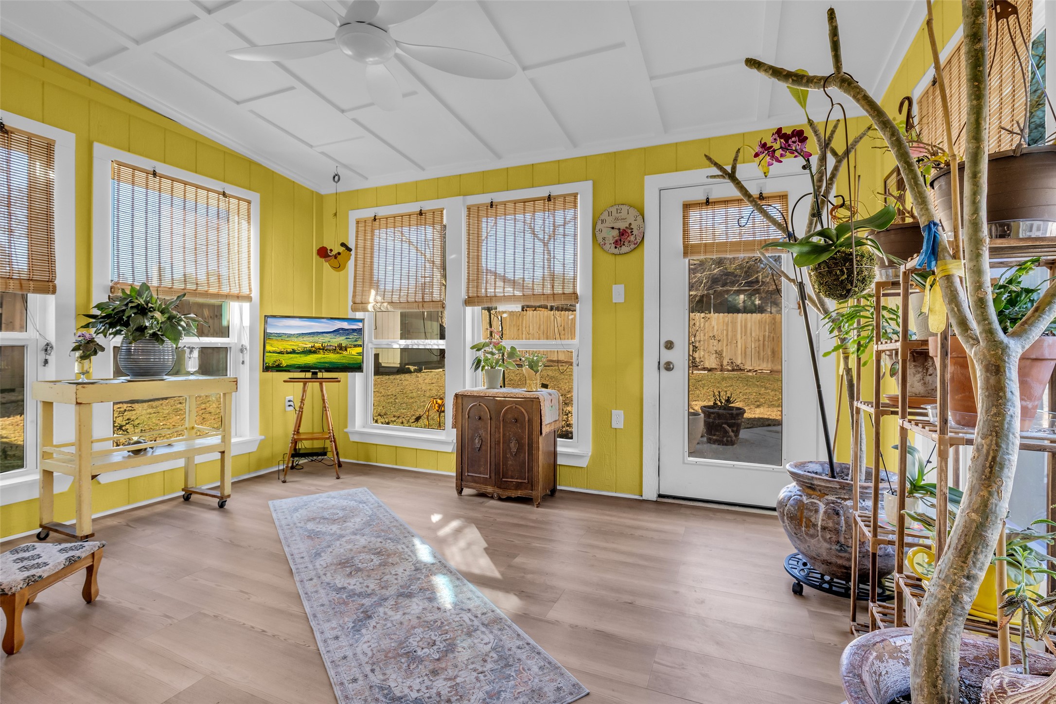 242 Sunset Path North Conroe, TX 77316 - Photo 3 of 37 BIG YARD. Year round enjoyment in this 2025 Sunroom! Filtered light with the existing shades. Glass door ahead leads to an expanded patio. 242 SUNSET PATH N - Request your tour today!