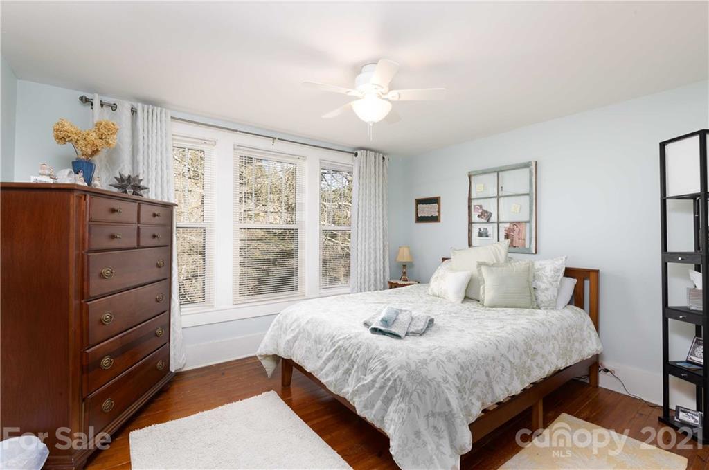39 Baileys Peak Road Spruce Pine, NC 28777 - Photo 15 of 47 a bedroom with a bed and a dresser