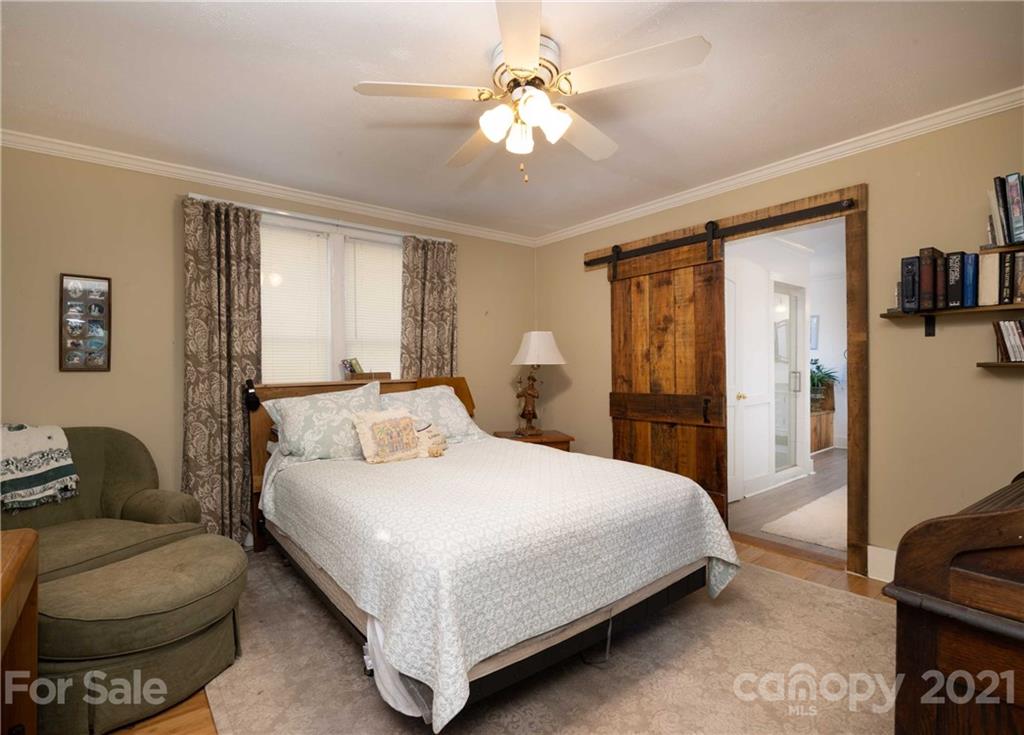 39 Baileys Peak Road Spruce Pine, NC 28777 - Photo 21 of 47 a bedroom with a large bed couch and a window