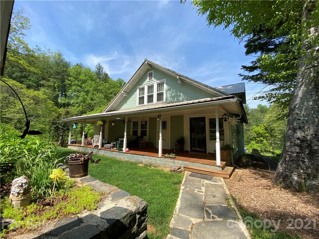 39 Baileys Peak Road Spruce Pine, NC 28777 - Photo 30 of 47 a front view of a house with a yard