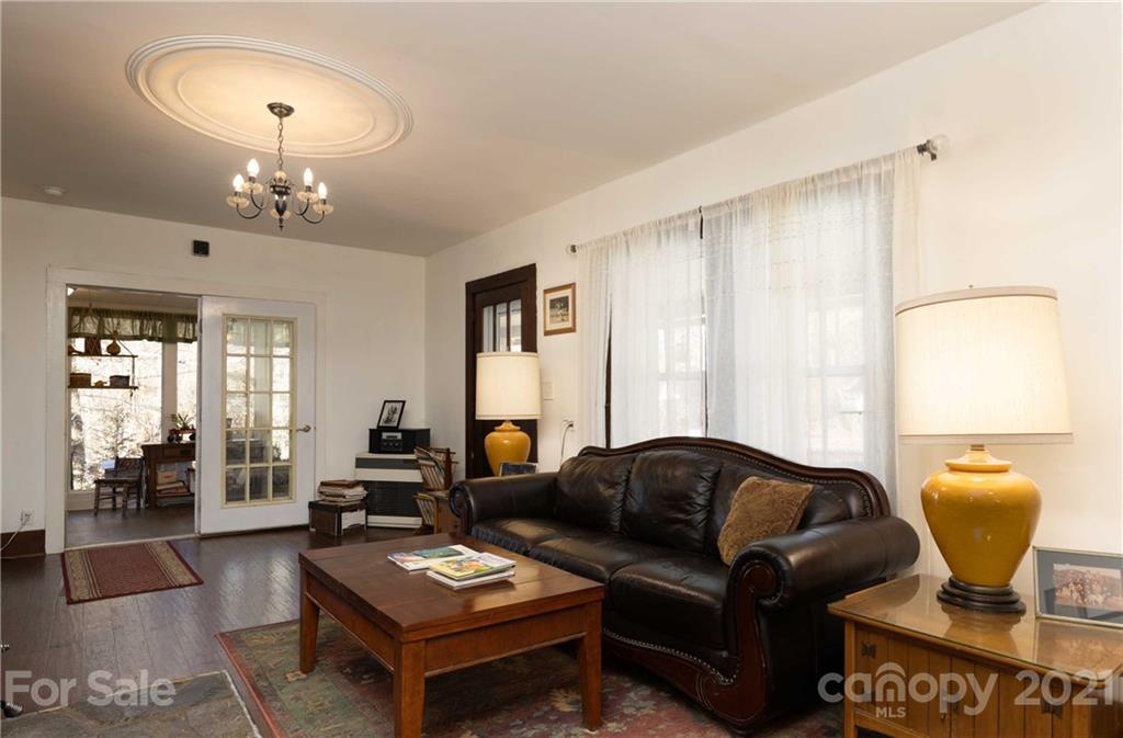 39 Baileys Peak Road Spruce Pine, NC 28777 - Photo 6 of 47 a living room with furniture a window and a chandelier
