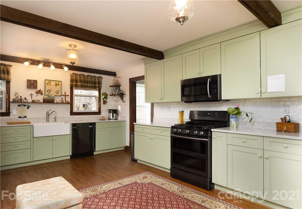 39 Baileys Peak Road Spruce Pine, NC 28777 - Photo 8 of 47 a kitchen with a sink cabinets and stainless steel appliances