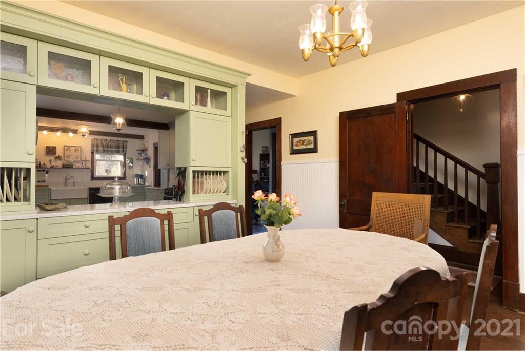39 Baileys Peak Road Spruce Pine, NC 28777 - Photo 10 of 47 a bed room with furniture and a chandelier