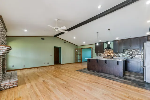 a view of kitchen and kitchen island with stainless steel appliances