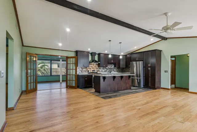 a kitchen with stainless steel appliances kitchen island wooden cabinets and granite counter tops