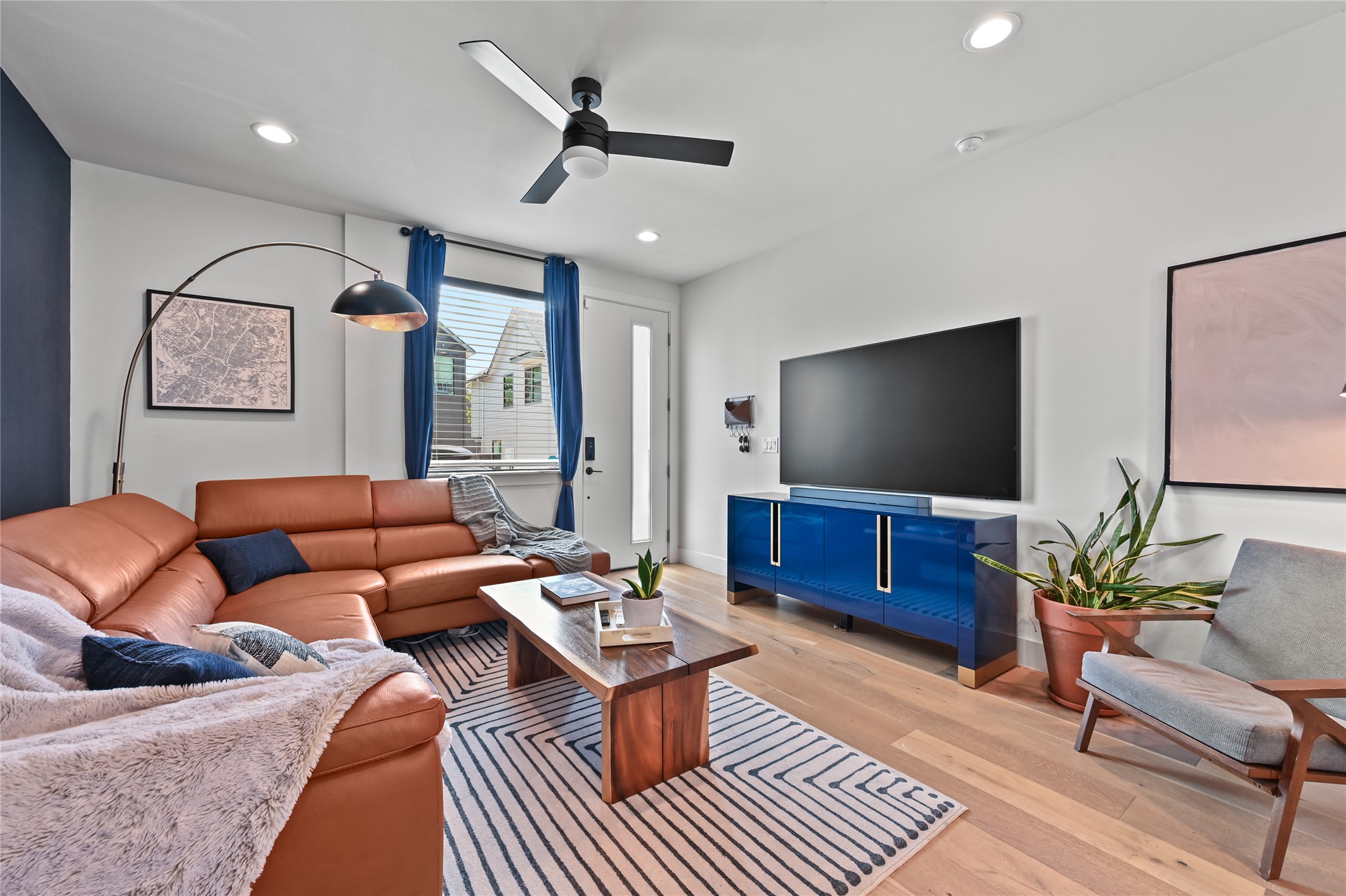 Living area featuring light wood-type flooring, ceiling fan, and recessed lighting