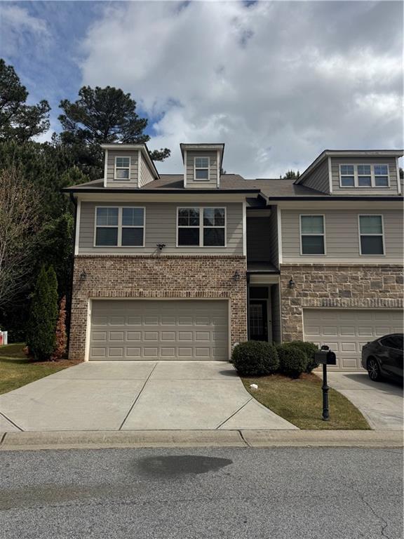 402 Mulberry Row Atlanta, GA 30354 - Photo 2 of 17 a front view of a house with a yard and garage