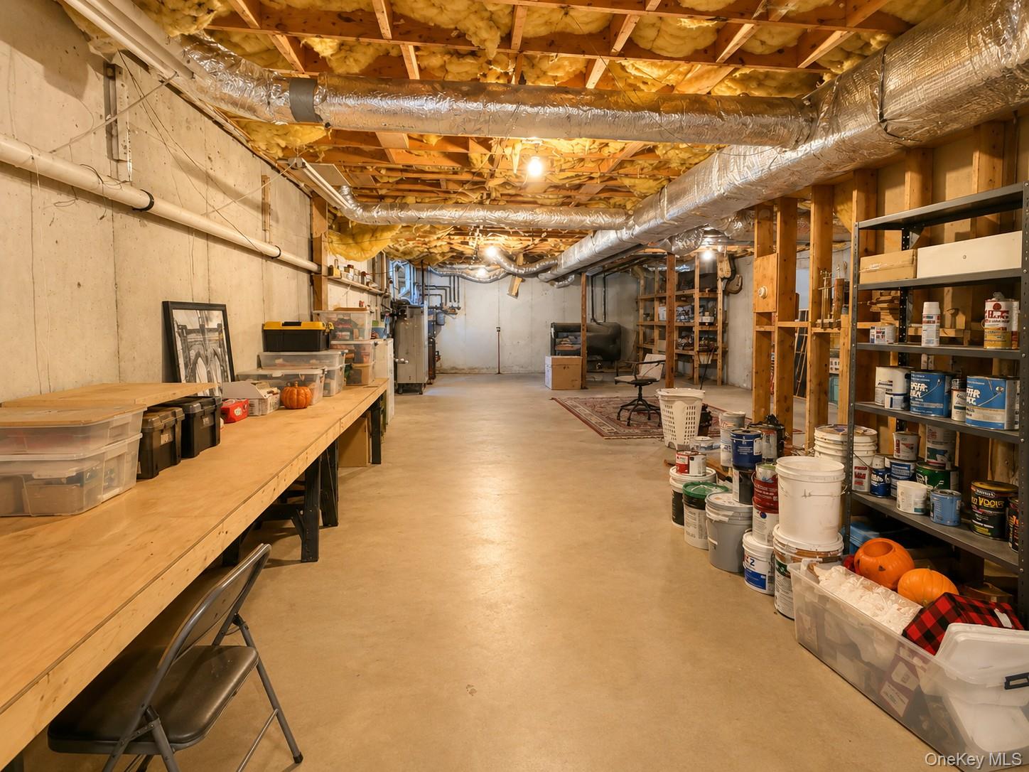 411 Mt Joy Road Middletown, NY 10941 - Photo 45 of 49 Unfinished basement featuring exposed wood joists, concrete flooring, Radiant heat and ample storage shelving
