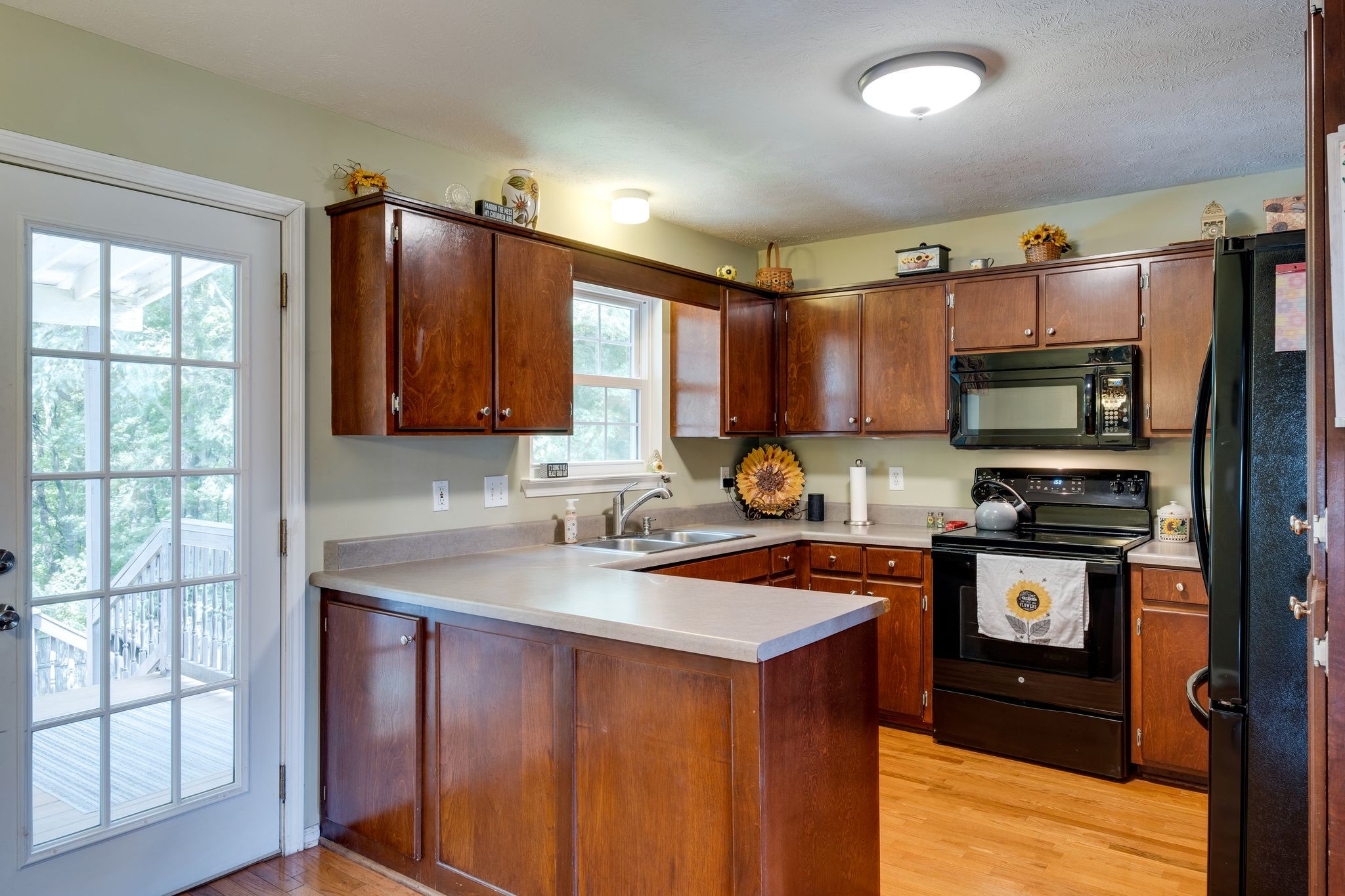 1040 Windtree Trace Mount Juliet, TN 37122 - Photo 11 of 30 a kitchen with stainless steel appliances granite countertop a stove a sink dishwasher a refrigerator and a microwave oven with wooden cabinets